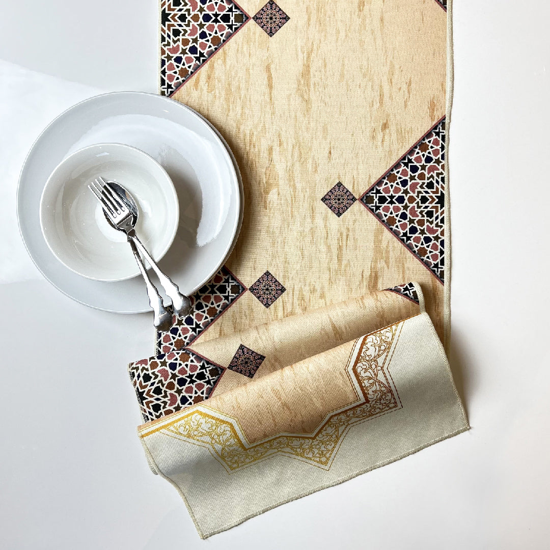 white tableware on folded beige table runner with brown Islamic print