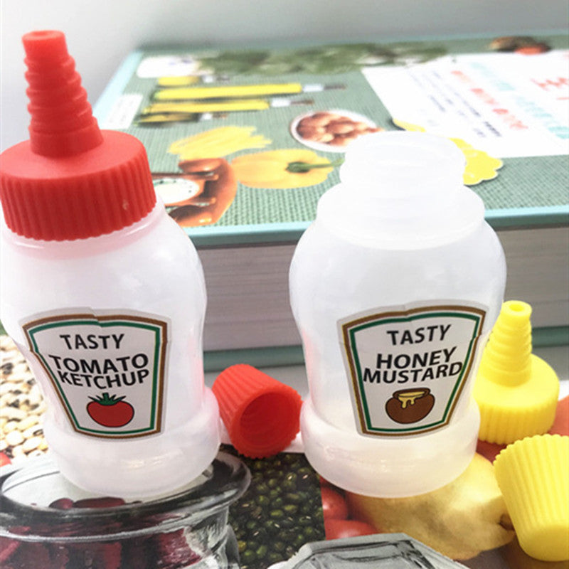 Two portable salad dressing and ketchup bottles
