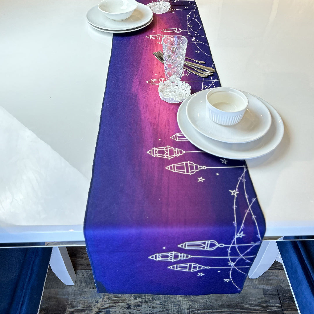 white tableware on a purple table runner with white lanterns print