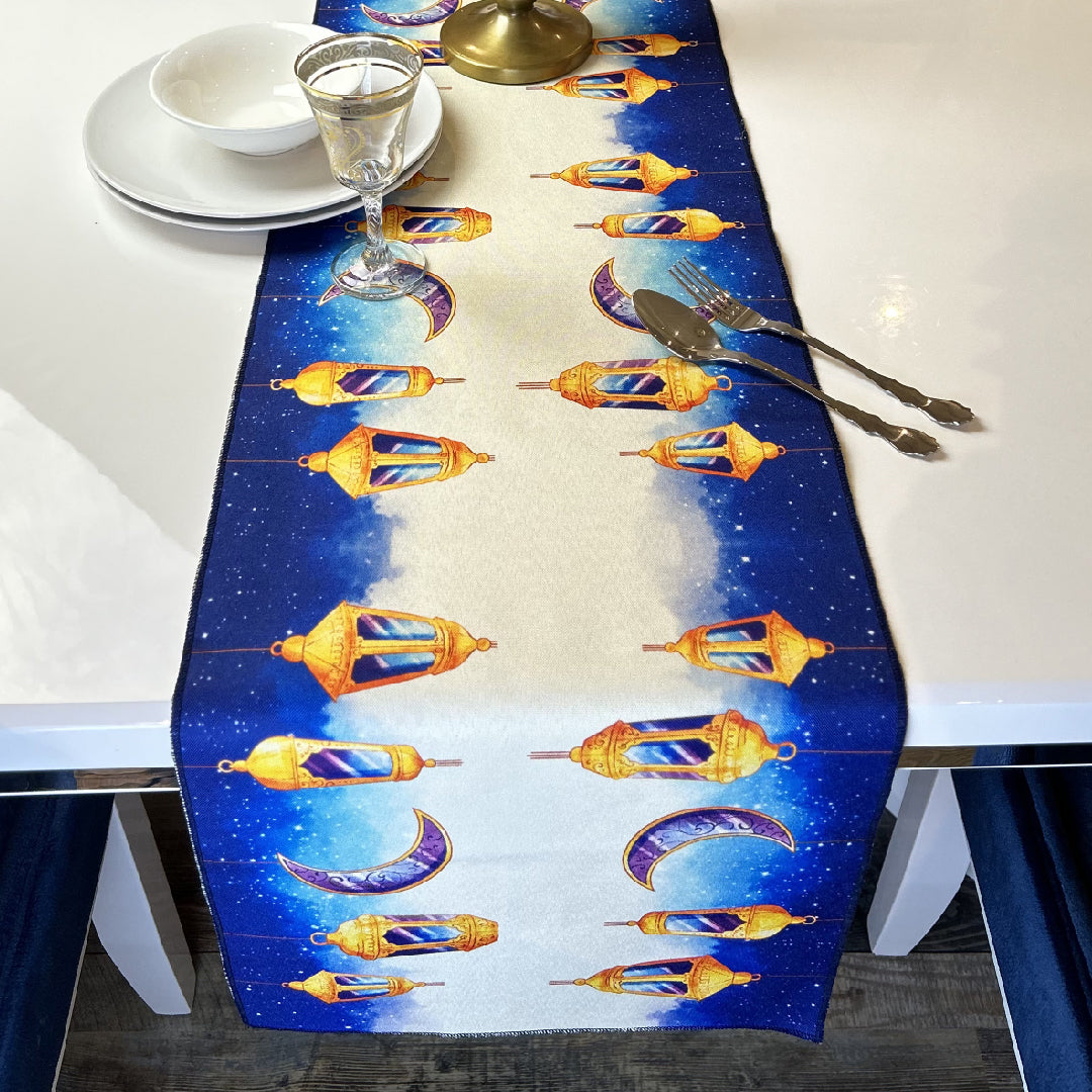 tableware on a blue table runner with golden lanterns and crescent print