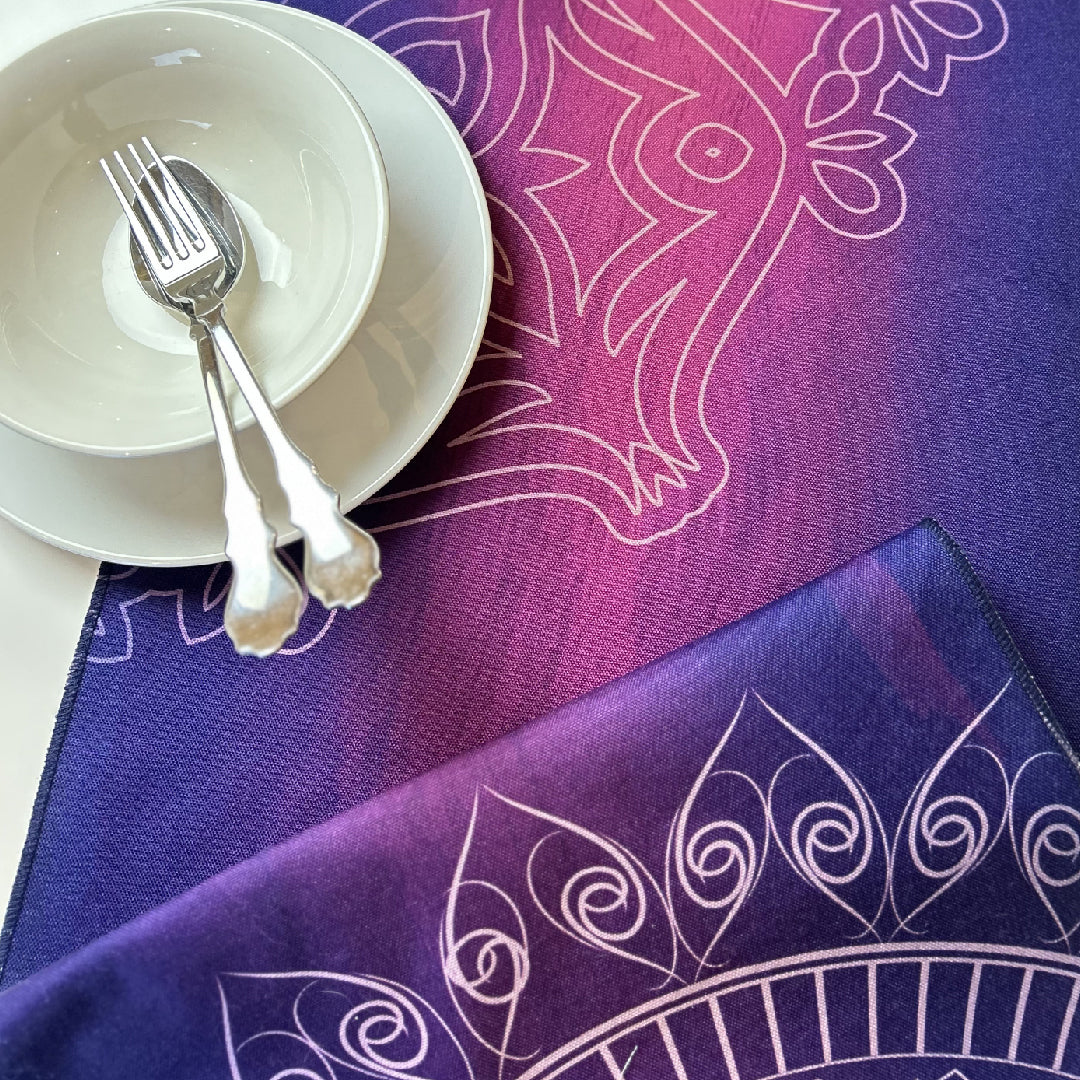 white tableware on a folded purple table runner with white Islamic floral motifs print