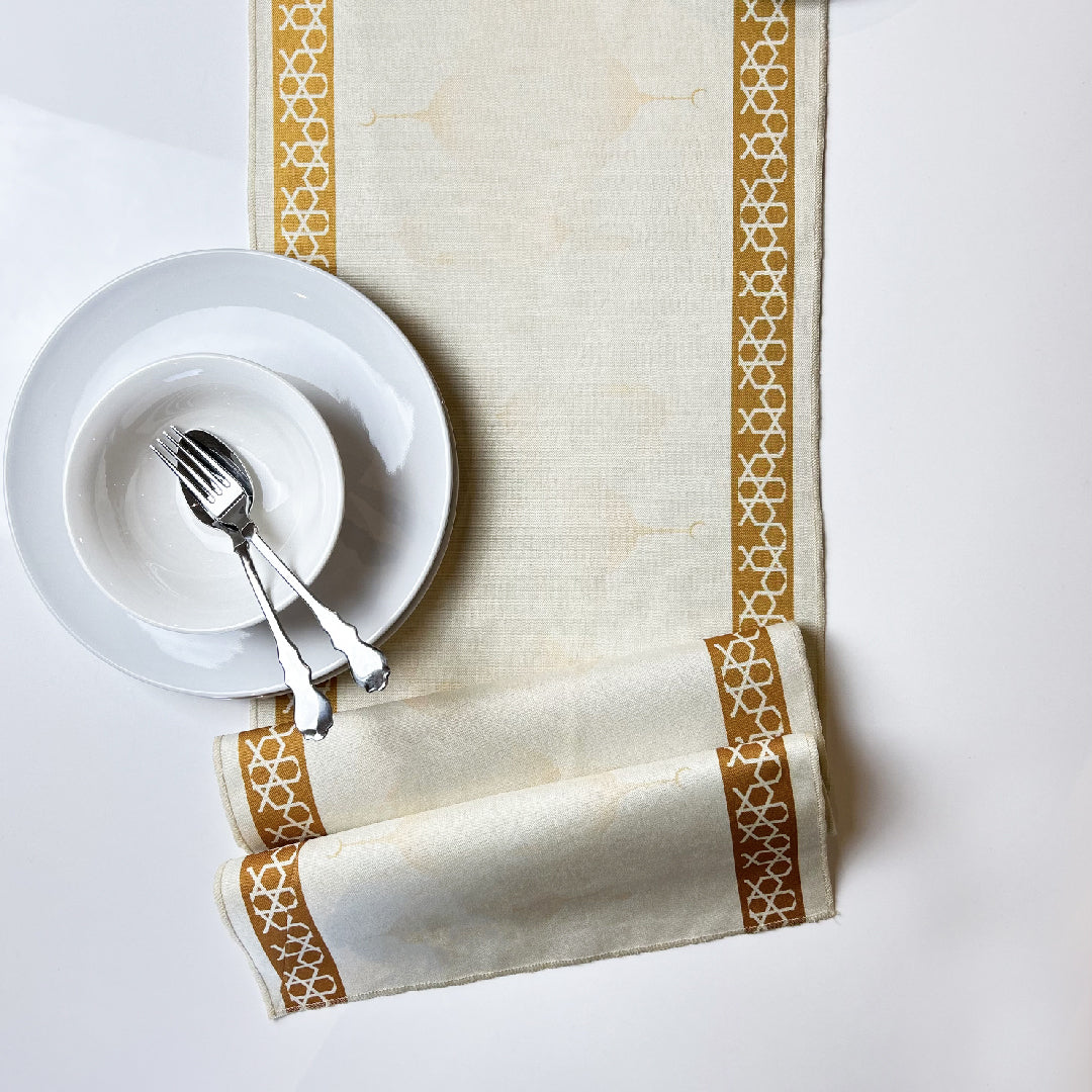 white tableware with folded beige table runner