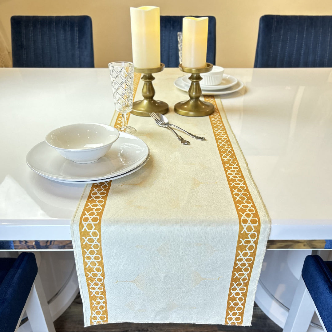 tableware with two candles on a beige table runner
