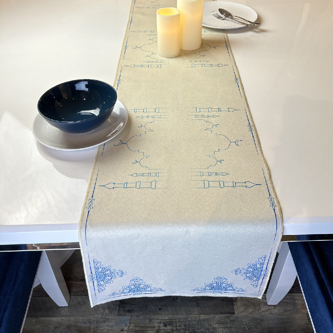 black and white tableware and candles on beige table runner
