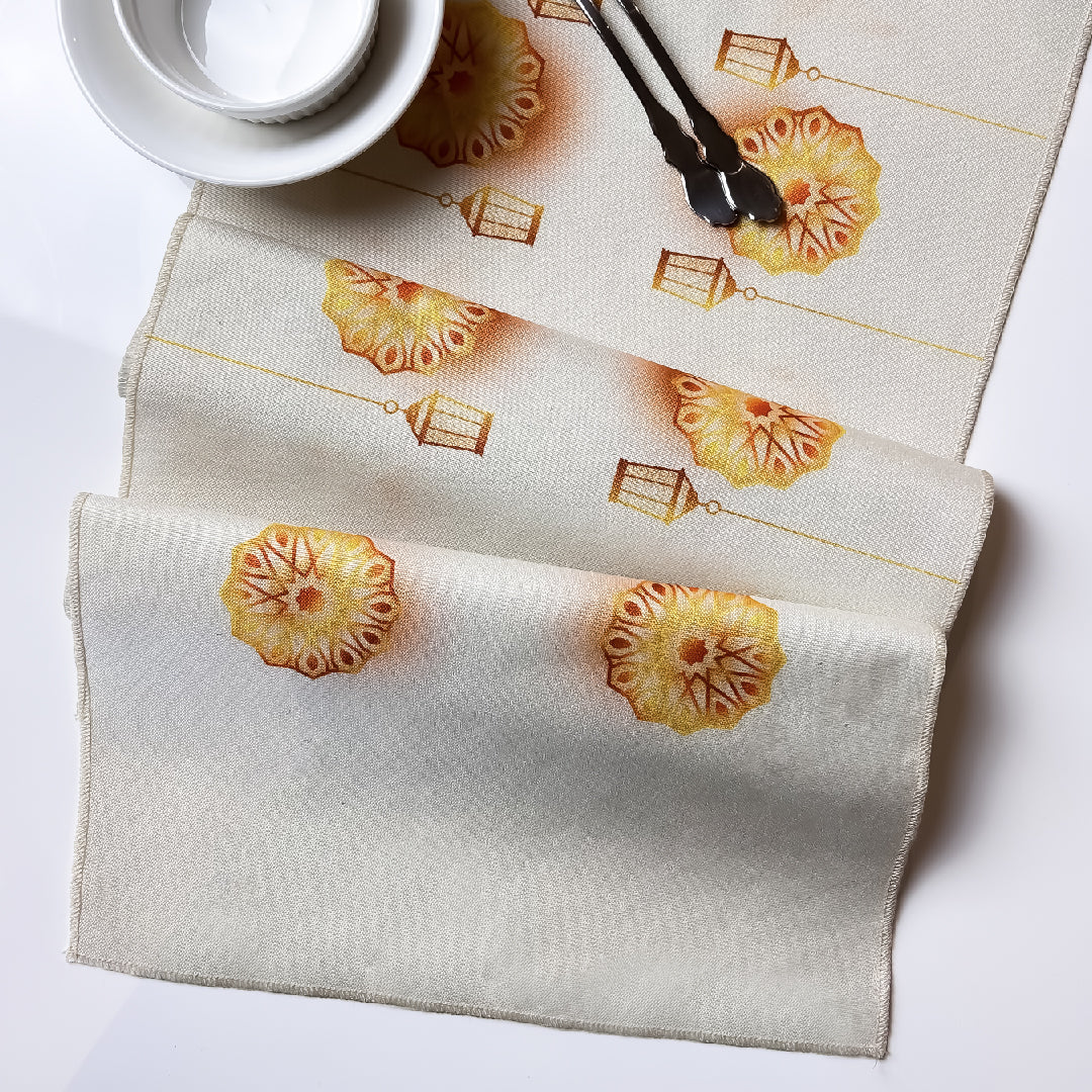 folded beige table runner with floral and lantern print