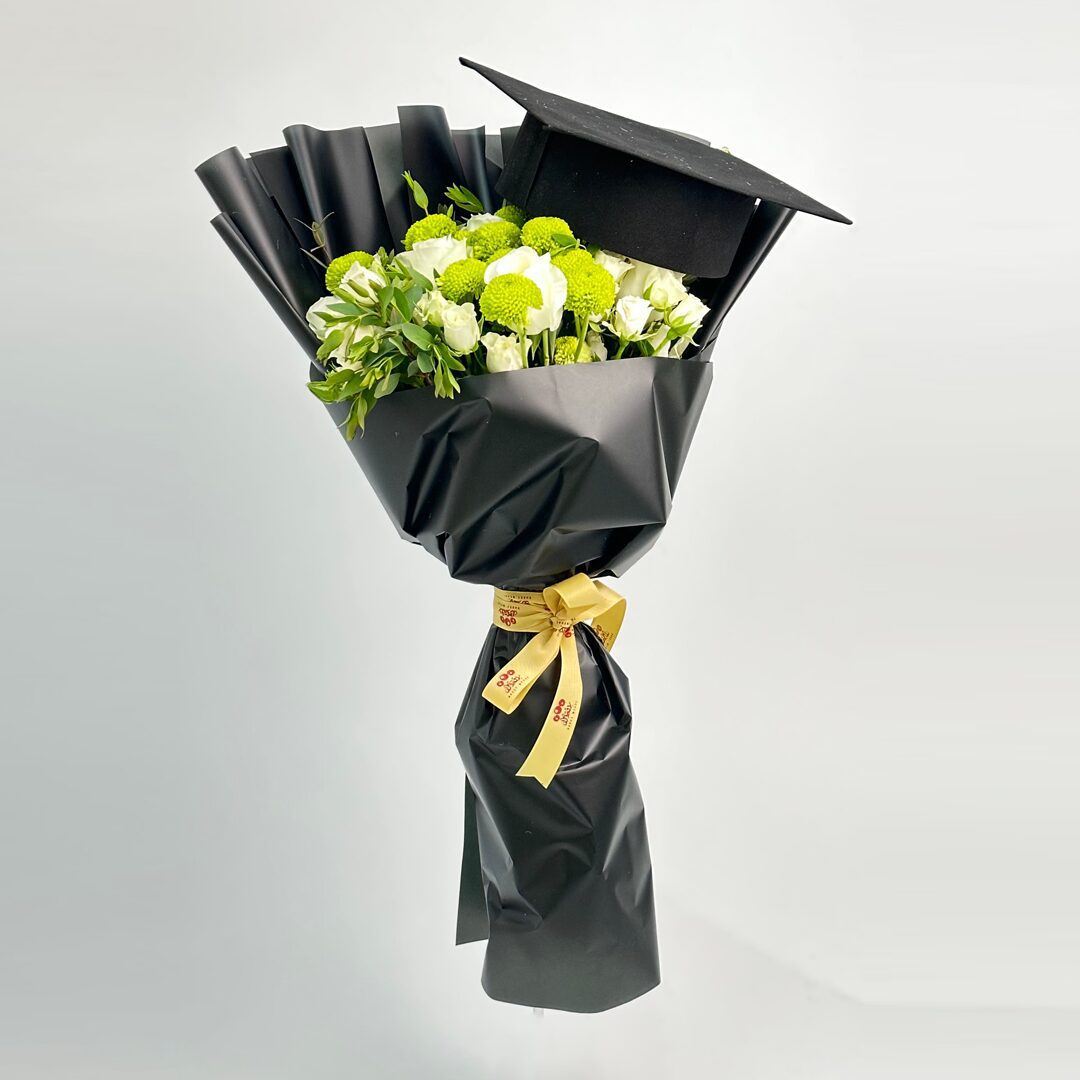 Flowers bouquet with graduation cap and cake