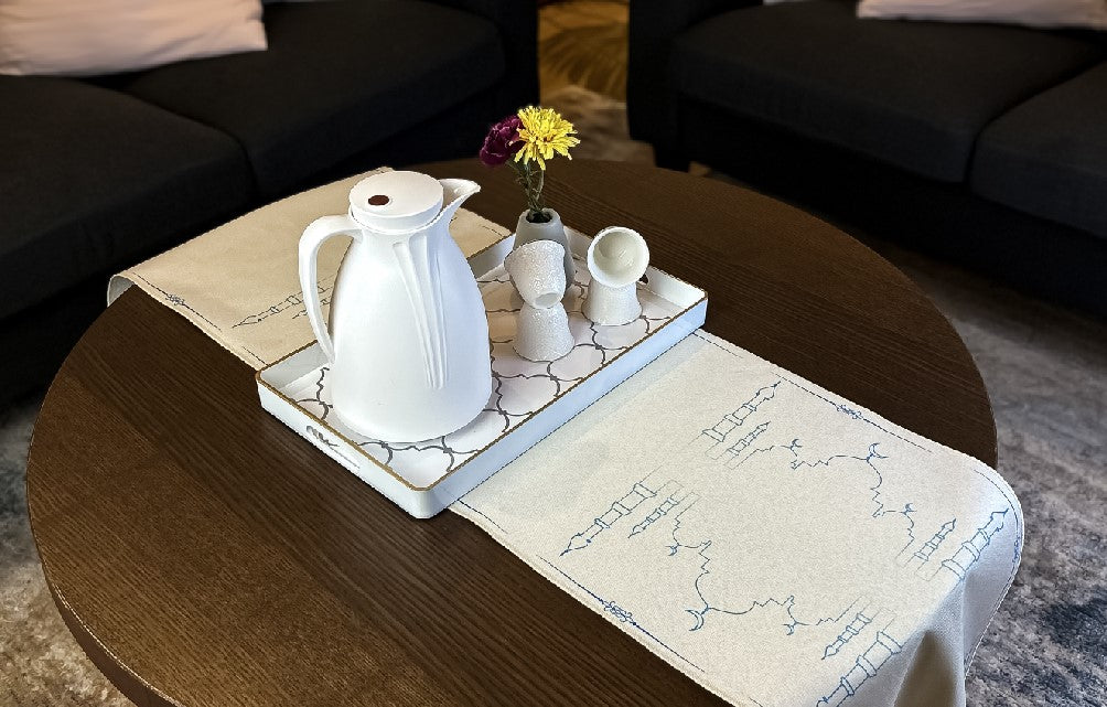 tea set and beige table runner on a wooden table
